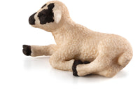 Mojo Black faced lamb lying down